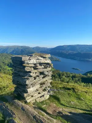 a stone tower on top of a hill with a lake at Cozy house closw in Lii