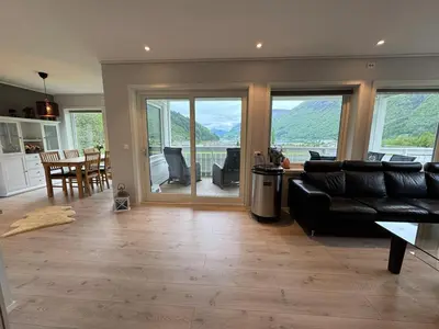 a living room with a couch and a table and chairs at Loen Panorama View in Loen