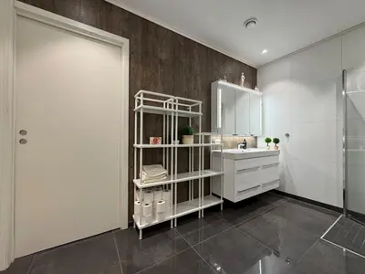 a white bathroom with a sink and a mirror at Loen Panorama View in Loen