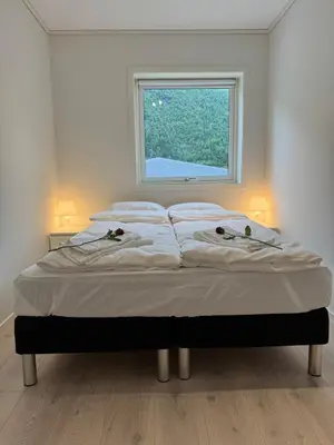 a bed in a room with a window at Loen Panorama View in Loen