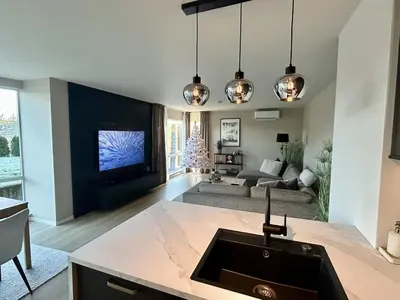 a living room with a couch and a tv at Apartment Suite in Os in Osøyro
