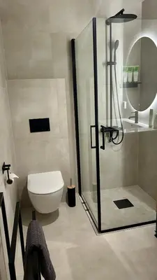 a bathroom with a shower and a toilet and a sink at Apartment Suite in Os in Osøyro