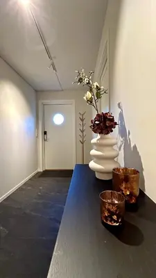 a room with a table with a vase on it at Apartment Suite in Os in Osøyro