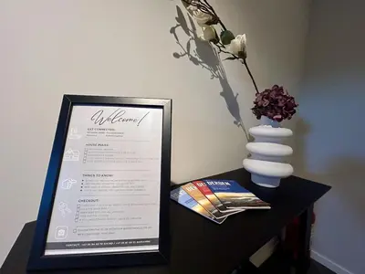 a table with a menu and a vase of flowers at Apartment Suite in Os in Osøyro