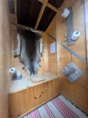 an inside view of a sauna with a cow hanging from the wall at Tretopphytta Kraggbua