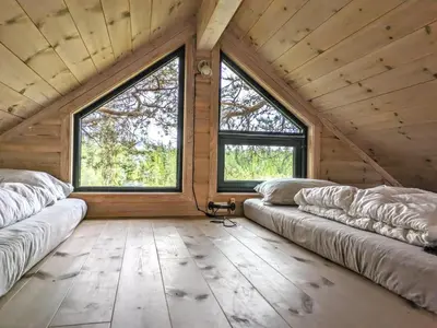 two couches in a room with two large windows at Tretopphytta Kraggbua