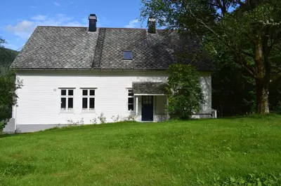an old white house on a grassy field at Large house by nature reserve