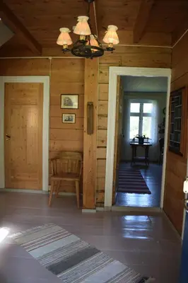 a room with a door and a chair in a cabin at Large house by nature reserve