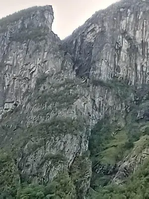 a rocky mountain with trees in front of it at Large house by nature reserve