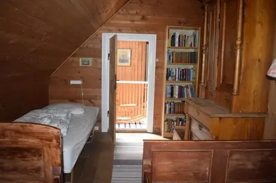 a bedroom with a bed and a book shelf with books at Large house by nature reserve