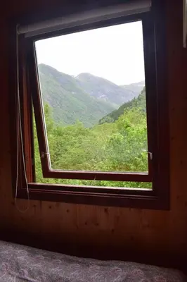 a window with a view of a mountain view at Skogshytte in Bjordal