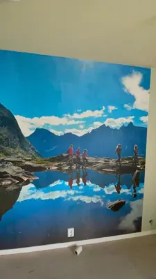 a large painting on a wall with people reflection in the water at Bakkebo in Åndalsnes