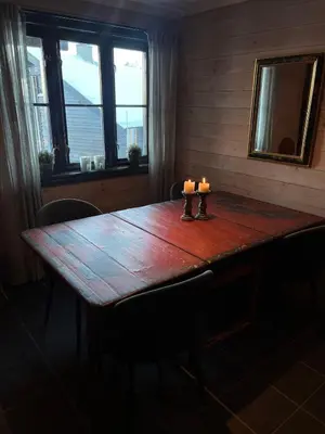 a wooden table with two candles on top of it at Ski in-ski out leilighet Hemsedal in Fausko