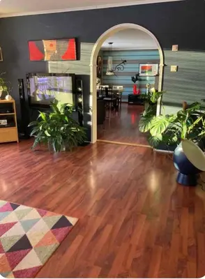 a living room with wooden floors and plants at Lilletun in Selbu