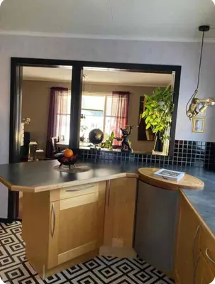 a kitchen with a counter and a large mirror at Lilletun in Selbu