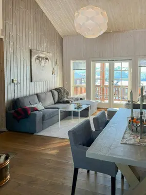 a living room with a couch and a table at Family-Friendly Mountain Cabin In Haukeli in Nesland