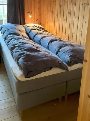 a row of pillows sitting on top of a bed at Family-Friendly Mountain Cabin In Haukeli in Nesland