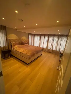 a bedroom with a bed and a wooden floor at Daniels House in Kristiansund