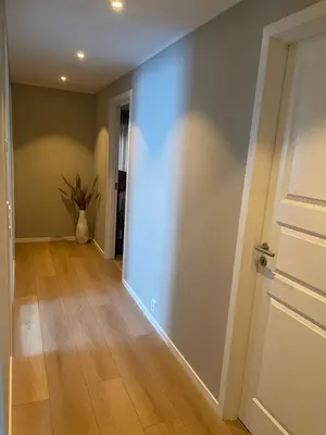 an empty room with a door and a wooden floor at Daniels House in Kristiansund