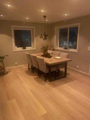 a dining room with a wooden table and chairs at Daniels House in Kristiansund
