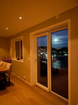 a room with a large window with a view of the water at Daniels House in Kristiansund