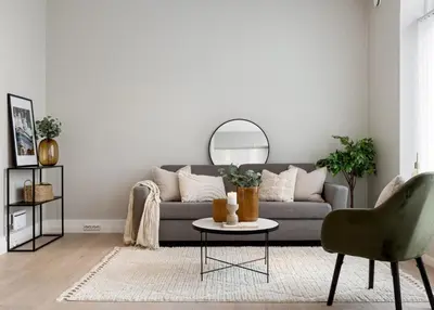 a living room with a gray couch and a table at Attractive and central apartment in Ålesund