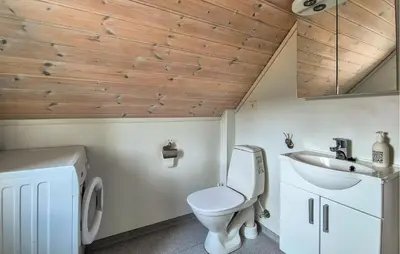 a bathroom with a toilet and a sink at Awesome Home In Fitjar With Wifi in Fitjar