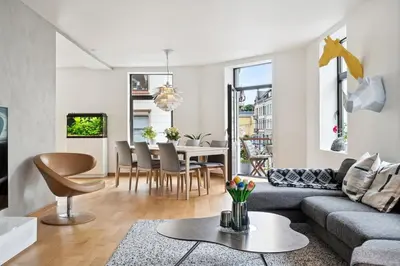a living room with a couch and a table at A Gem in the Heart of Ålesund in Ålesund