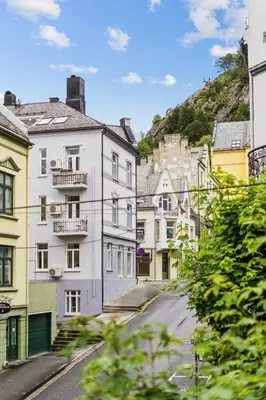 a city street with white buildings on a hill at A Gem in the Heart of Ålesund in Ålesund