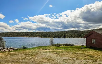 a house on the shore of a large lake at 2 Bedroom Lovely Home In Nesbyen in Nesbyen