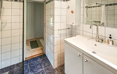 a bathroom with a sink and a shower at Stunning Home In Edland With Sauna in Nesland