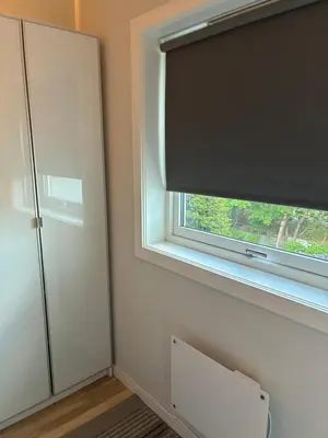 a window with a black blind in a room at FINN-bruker in Lii