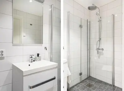 a white bathroom with a sink and a shower at Large luxurious apartment with private terrace and parking in Bergen