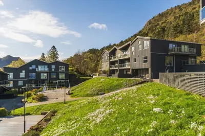 an apartment building with a hill in the background at Large luxurious apartment with private terrace and parking in Bergen
