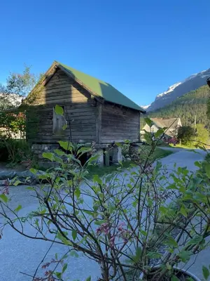 an old wooden house with a green roof at Arnestova - villagehouse in Loen in Loen