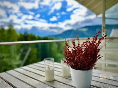 a table with two candles and a potted plant at Family friendly apartment in Hafjell ski in-out, fireplace, sauna and wifi in Hafjell