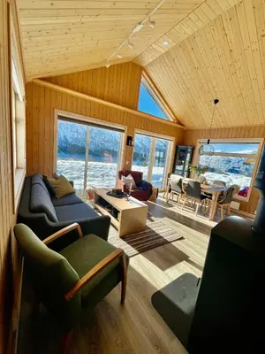 a living room with a couch and a table at Hytte sentralt i Myrkdalen in Vossevangen
