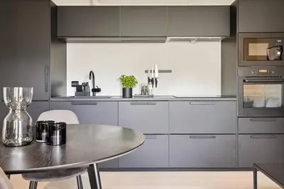 a kitchen with a metal table and a table and a tableablish at Apartment Lademoen Trondheim in Trondheim