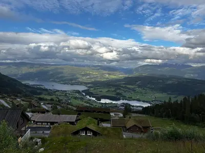 a view of a town with a lake and mountains at Apartment Øvre Tråstølen - Voss in Vossevangen