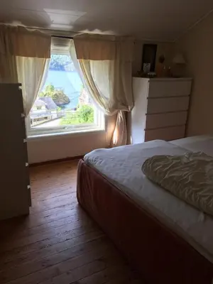 a bedroom with a bed and a large window at Markhus Apartment Near Langfoss in Markhus