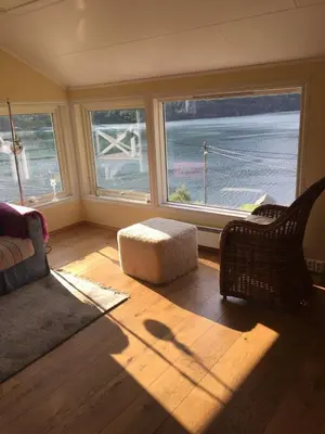 a living room with a couch and a chair and windows at Markhus Apartment Near Langfoss in Markhus