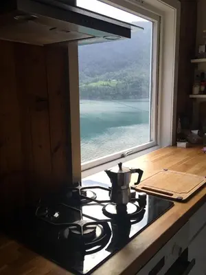 a tea kettle sitting on a stove in front of a window at Markhus Apartment Near Langfoss in Markhus