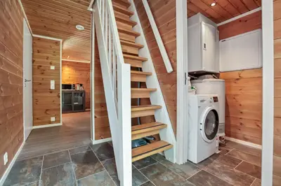 a staircase in a tiny house with a washing machine at Large nice apartment in Myrkdalen in Vossevangen