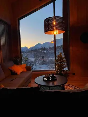a living room with a christmas tree and a large window at New Apartment, Porch & Sauna, Sunnmøre Alps in Stranda