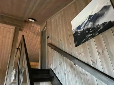 a staircase in a house with a picture on the wall at New Apartment, Porch & Sauna, Sunnmøre Alps in Stranda