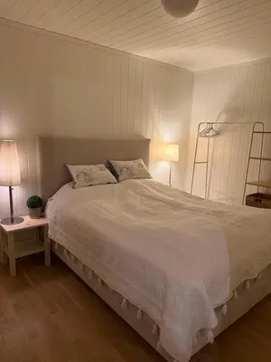 a bedroom with a large white bed with two pillows at Ski in-Ski out with Mountain View at Voss in Vossevangen