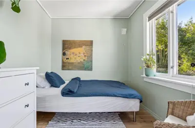 a bedroom with a bed and a window at Bright apartment with mountain views in Bergen