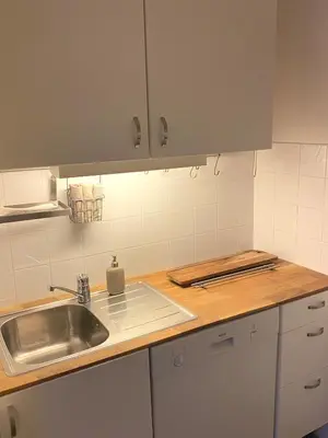 a kitchen with a sink and a counter at Unique relaxed corner flat in central Bergen in Bergen