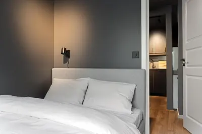 a white bed with white pillows in a bedroom at King bed - Free parking - Renovated June 2025 in Bergen