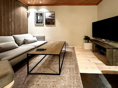 a living room with a couch and a coffee table at Nature-Close Cabin By Trysil Mountain in Trysil